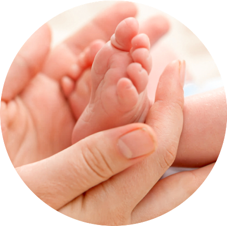 Newborn baby foot in gentle adult hands – symbolizing compassionate newborn care and test tube baby center in Bhopal.