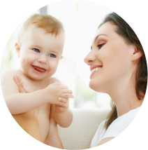 Smiling mother holding her happy baby – trusted obstetrician-gynecologist in Bhopal and leading test tube baby center for family care.