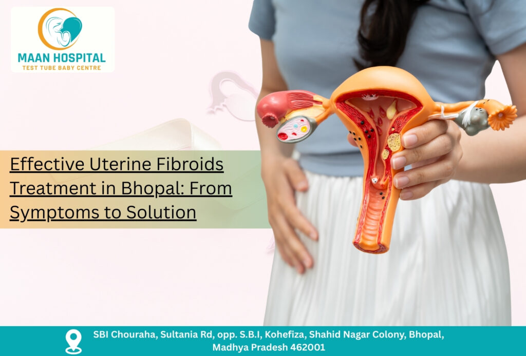 Doctor holding uterus model showing fibroids for Uterine Fibroids Treatment in Bhopal at Maan Hospital.