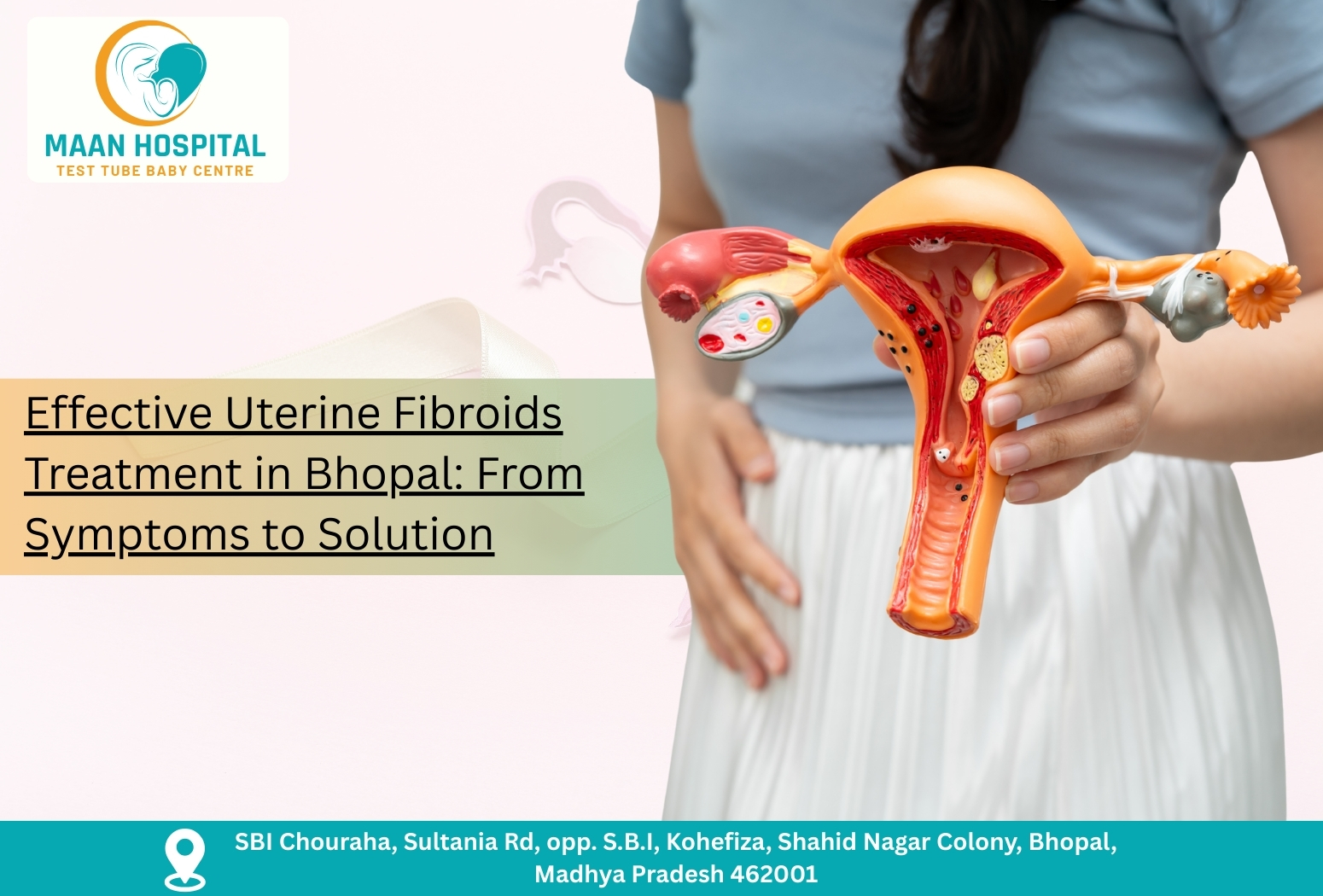 Doctor holding uterus model showing fibroids for Uterine Fibroids Treatment in Bhopal at Maan Hospital.